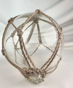 Vintage Clear Glass Fishing Float with Intricate Rope Netting – 7" Coastal Buoy with Internal "Sea-Mist" Patina Hand Blown