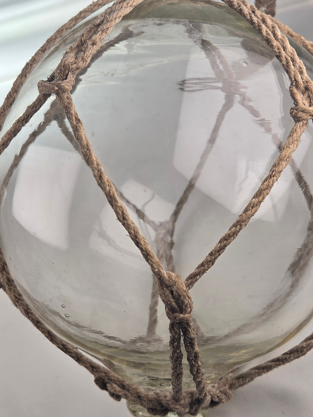 Vintage Clear Glass Fishing Float with Intricate Rope Netting – 7" Coastal Buoy with Internal "Sea-Mist" Patina Hand Blown