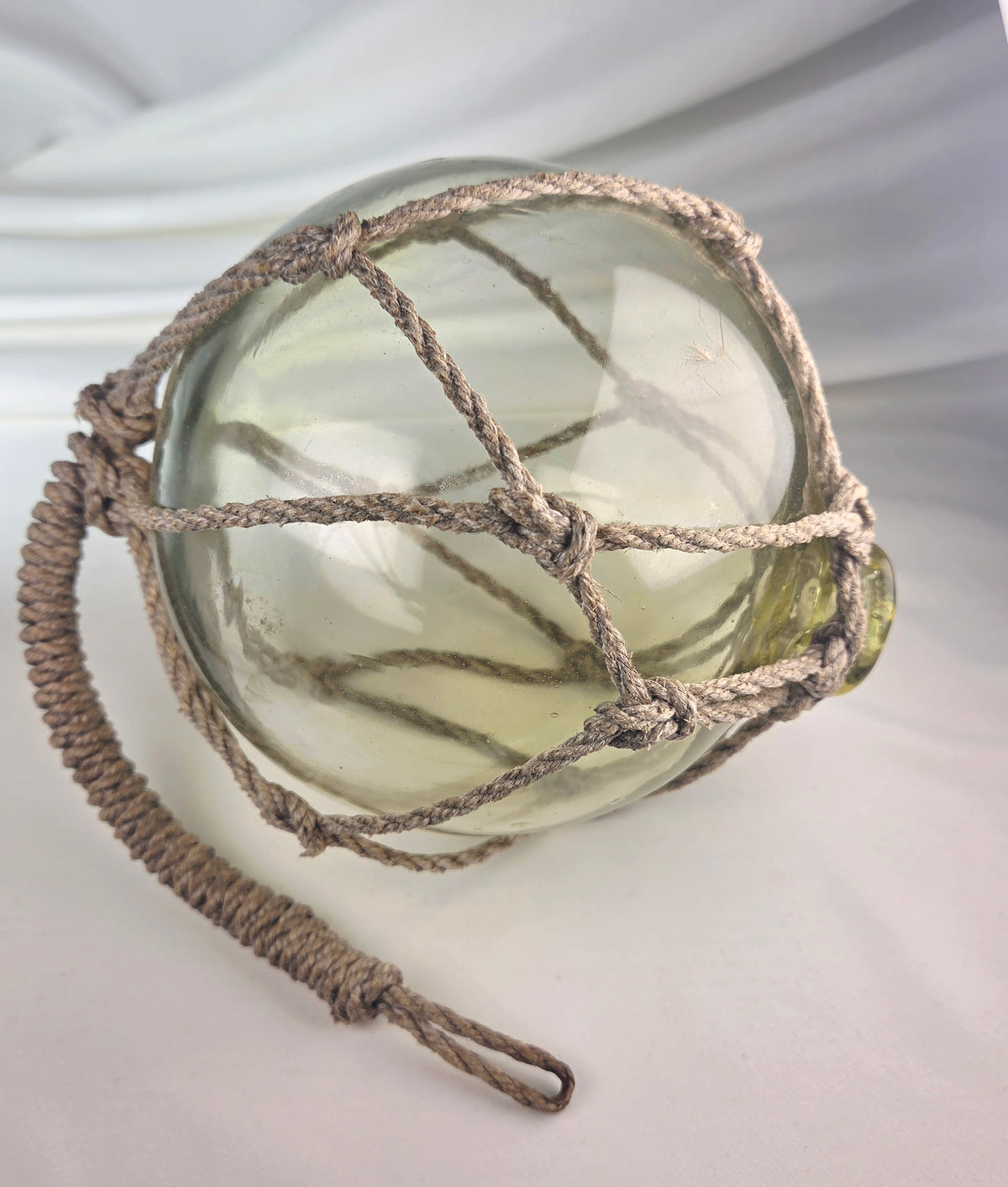 Vintage Light Amber Glass Fishing Float with Rope Netting – 7" Maritime Buoy with Internal Sea Mist Patina Hand Blown