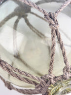 Vintage Light Amber Glass Fishing Float with Rope Netting – 7" Maritime Buoy with Internal Sea Mist Patina Hand Blown
