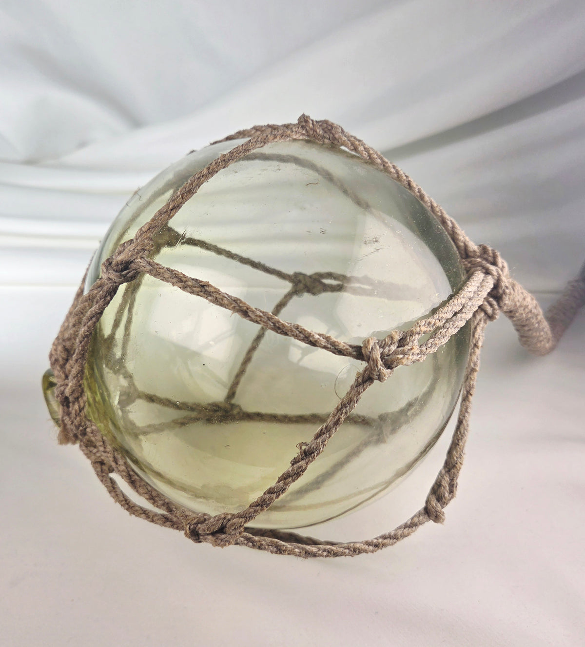 Vintage Light Amber Glass Fishing Float with Rope Netting – 7" Maritime Buoy with Internal Sea Mist Patina Hand Blown