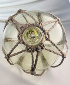 Vintage Light Amber Glass Fishing Float with Rope Netting – 7" Maritime Buoy with Internal Sea Mist Patina Hand Blown