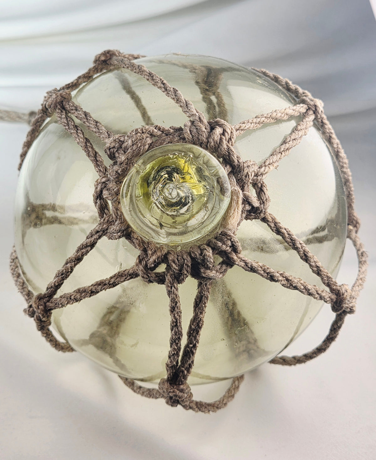 Vintage Light Amber Glass Fishing Float with Rope Netting – 7" Maritime Buoy with Internal Sea Mist Patina Hand Blown