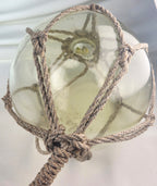 Vintage Light Amber Glass Fishing Float with Rope Netting – 7" Maritime Buoy with Internal Sea Mist Patina Hand Blown