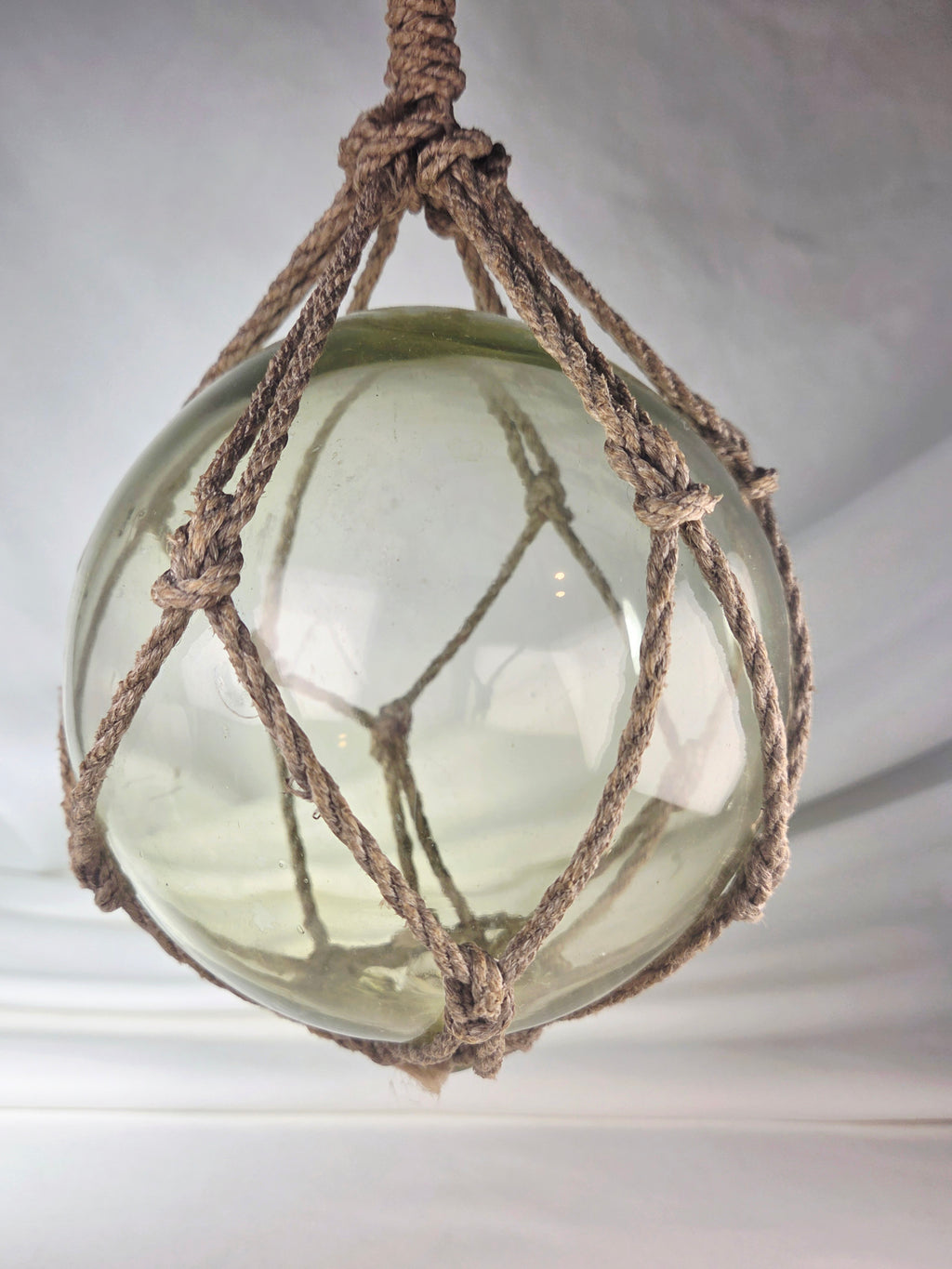 Vintage Light Amber Glass Fishing Float with Rope Netting – 7" Maritime Buoy with Internal Sea Mist Patina Hand Blown