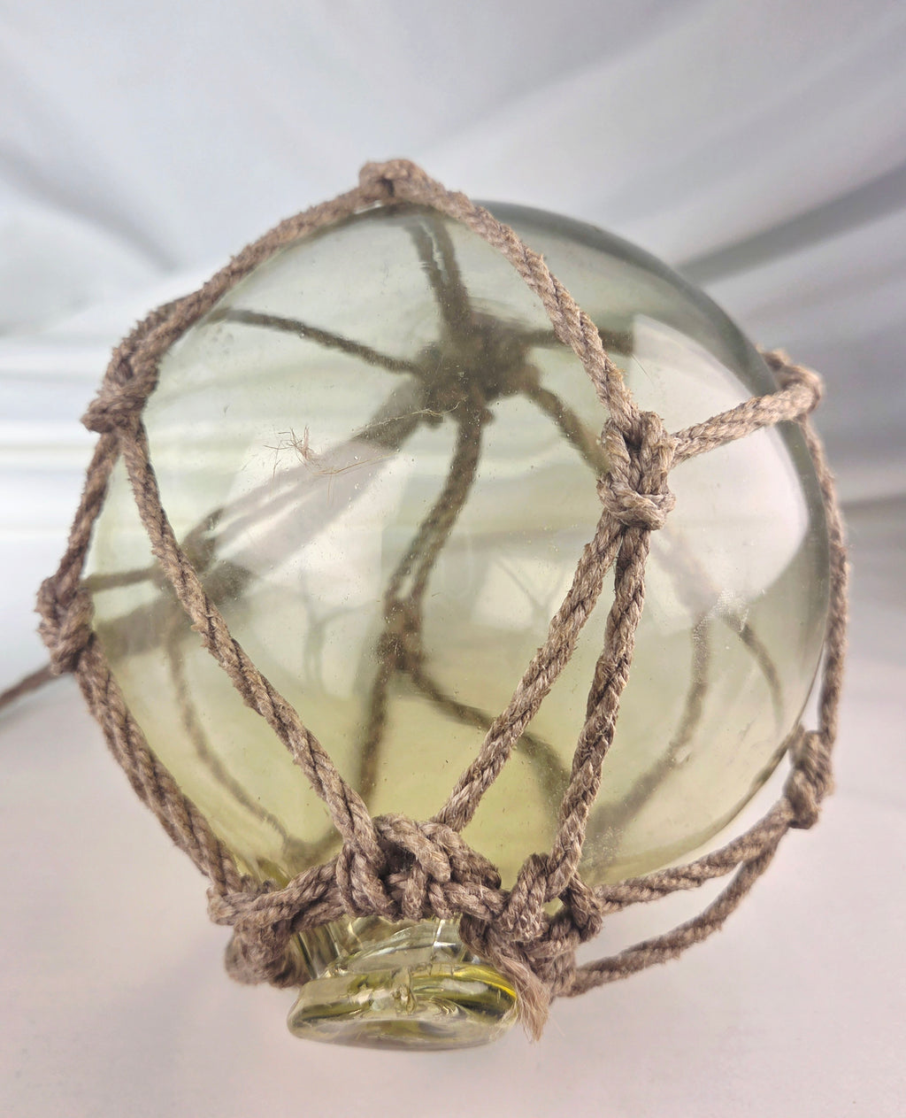 Vintage Light Amber Glass Fishing Float with Rope Netting – 7" Maritime Buoy with Internal Sea Mist Patina Hand Blown