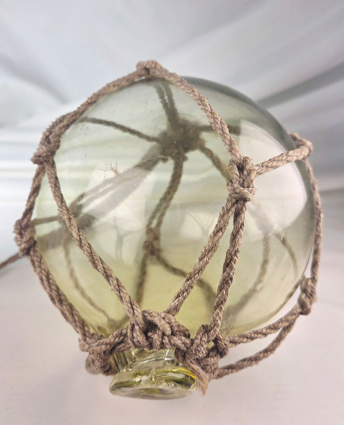 Vintage Light Amber Glass Fishing Float with Rope Netting – 7" Maritime Buoy with Internal Sea Mist Patina Hand Blown