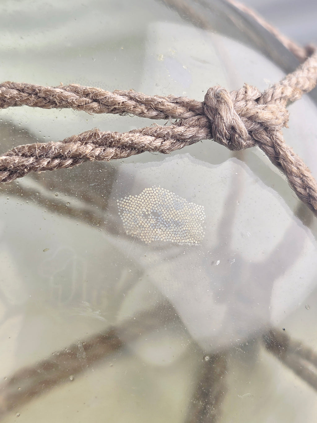 Vintage Light Amber Glass Fishing Float with Rope Netting – 7" Maritime Buoy with Internal Sea Mist Patina Hand Blown